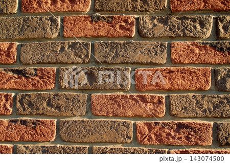 Textured brick wall with dark and reddish-orange clay bricks Textured brick wall with dark and reddish-orange clay bricks 143074500