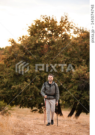 Joyful hiker enjoying the beauty of nature on a sunny autumn day Joyful hiker enjoying the beauty of nature on a sunny autumn day 143074748