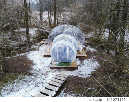 Transparent Bubble Tent on Wooden Platform in Snowy Forest, Belarus Transparent Bubble Tent on Wooden Platform in Snowy Forest, Belarus 143075155