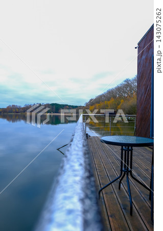 Lakeside deck and modern wood building by a calm Belarus lake 143075262