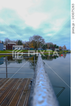 Lakeside pier and marina in Belarus with buoy and cloudy sky view 143075263