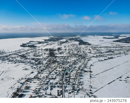 Aerial winter view of a Belarusian town with grid streets and fields 143075278