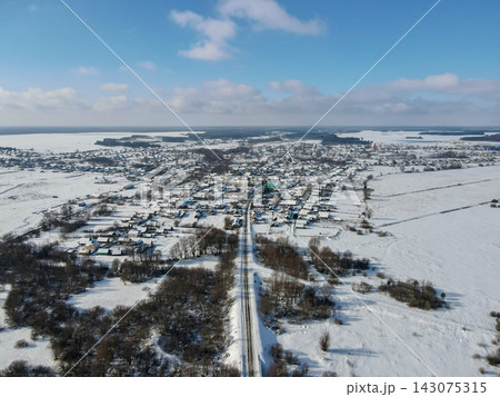 Aerial winter view of a Belarus village and flat snow fields Aerial winter view of a Belarus village and flat snow fields 143075315