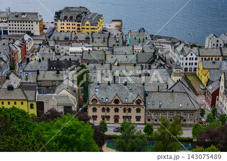 Aerial view of coastal town with traditional architecture, stone buildings and harbor, Norway Aerial view of coastal town with traditional architecture, stone buildings and harbor, Norway 143075489