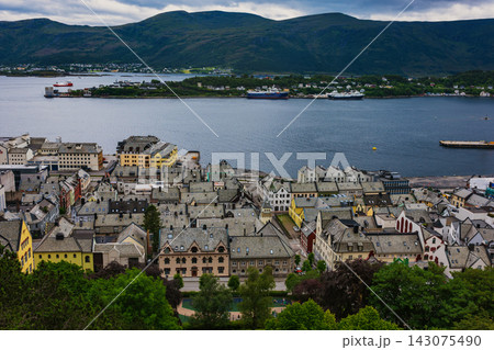 Aerial view of coastal town with fjord, mountains and cargo ships, Norway 143075490