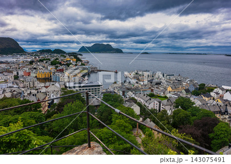 Elevated view of coastal town with harbor and mountains, Ales Norway 143075491