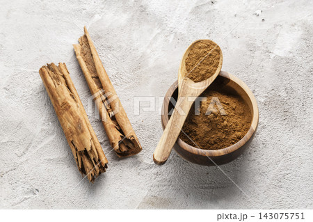 Cinnamon Sticks and Powder on White Background Cinnamon Sticks and Powder on White Background 143075751