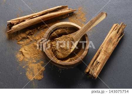 Cinnamon Sticks and Powder on Gray Slate 143075754