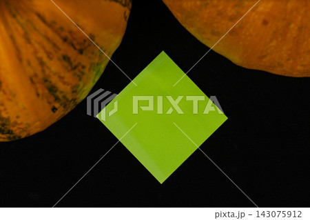 Festive pumpkins and a green decoration for Halloween celebration Festive pumpkins and a green decoration for Halloween celebration 143075912