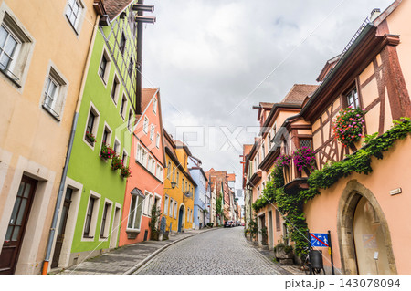 Cobblestone street with colorful half-timbered houses in Rothenburg ob der Tauber old town, Germany Cobblestone street with colorful half-timbered houses in Rothenburg ob der Tauber old town, Germany 143078094