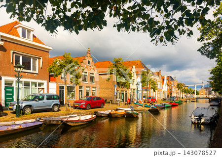 Beautiful buildings of Alkmaar and water canal at day. Netherlands Beautiful buildings of Alkmaar and water canal at day. Netherlands 143078527