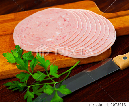 Sliced ham on wooden background 143078618