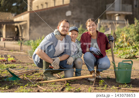 Family of farmers standing in the garden Family of farmers standing in the garden 143078653