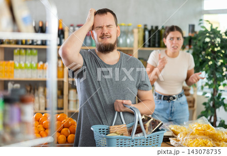 Family quarrel between a husband and wife in grocery supermarket Family quarrel between a husband and wife in grocery supermarket 143078735