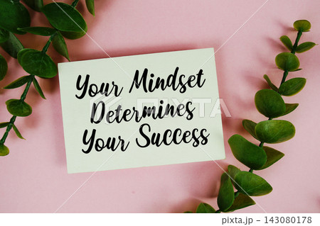 Your Mindset Determines Your Success text written on paper card top view on pink background Your Mindset Determines Your Success text written on paper card top view on pink background 143080178
