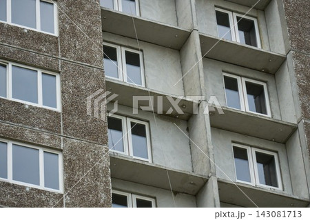 Mid shot showing textured gray concrete slabs and newly fitted plastic windows on residential block Mid shot showing textured gray concrete slabs and newly fitted plastic windows on residential block 143081713