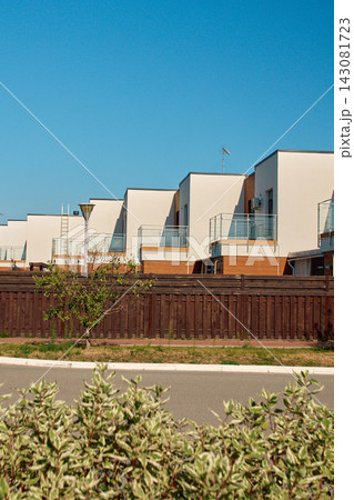 Modern residential townhouses with step architecture under clear blue sky Modern residential townhouses with step architecture under clear blue sky 143081723