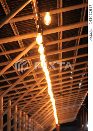 Low Angle View of String Lights Under Industrial Roof Low Angle View of String Lights Under Industrial Roof 143082617