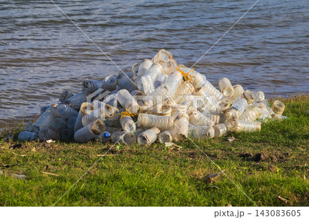 Plastic bottle trash pile near water Plastic bottle trash pile near water 143083605