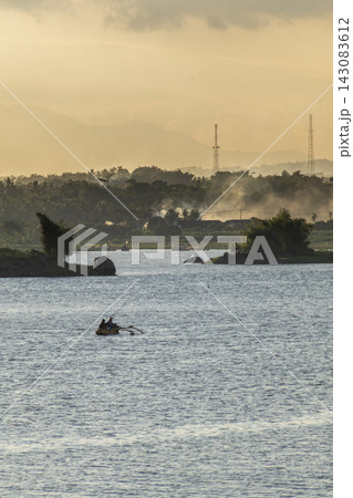 Traditional boat on a lake under a hazy sky 143083612