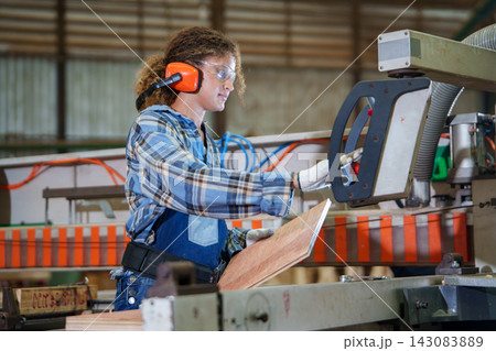 Industrial Worker Operating Woodworking Machinery in Factory 143083889