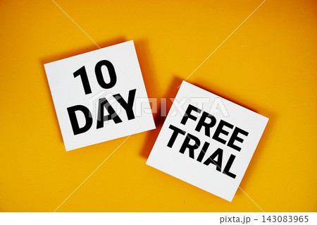 100 Day Free Trial text written on paper notes top view on yellow background 143083965
