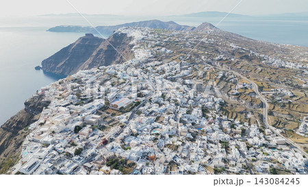 High aerial panoramic view of Santorini island Caldera with white traditional houses on steep volcanic cliff top overlooking Aegean Sea in Greece High aerial panoramic view of Santorini island Caldera with white traditional houses on steep volcanic cliff top overlooking Aegean Sea in Greece 143084245