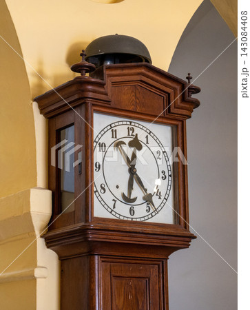 brown wood retro floor clock against the wall. High quality photo brown wood retro floor clock against the wall. High quality photo 143084408