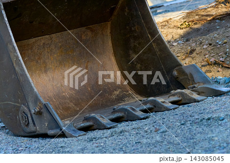 Close up excavator bulldozer bucket on construction site Close up excavator bulldozer bucket on construction site 143085045