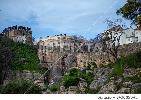 Puente Nuevo dramatic bridge spanning a deep limestone gorge creating iconic architectural landmark in Ronda, Spain. Puente Nuevo dramatic bridge spanning a deep limestone gorge creating iconic architectural landmark in Ronda, Spain. 143085645