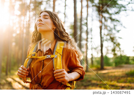 Stylish woman enjoying autumn weather in the park. Autumn mood. Hiking. Stylish woman enjoying autumn weather in the park. Autumn mood. Hiking. 143087491