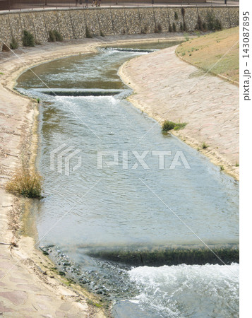 Water of the Queiles river flowing over low weirs in its stone channel, Tarazona Water of the Queiles river flowing over low weirs in its stone channel, Tarazona 143087895