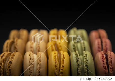 macaroons of different colors on a black background macaroons of different colors on a black background 143089092