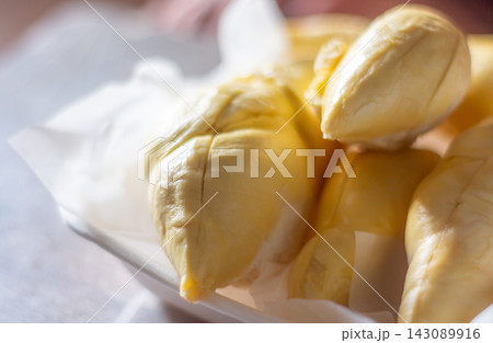 Fresh Thai durian flesh with creamy texture and rich flavor, tropical fruit enjoyed by many worldwide. 143089916