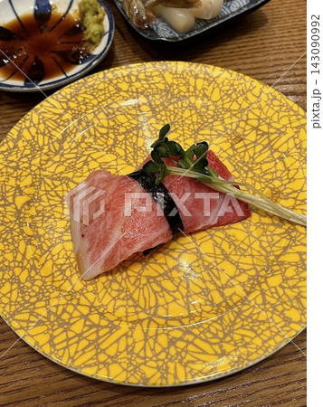 An assortment of fresh sushi, artfully arranged with a variety of toppings and vibrant colors. This traditional Japanese dish combines vinegared rice, seafood, and vegetables for an experience. 143090992