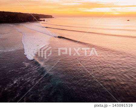 Sunset view of gentle waves washing onto a tropical coastline 143091519