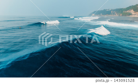 Drone view of powerful ocean waves breaking in blue water near the coast 143091528