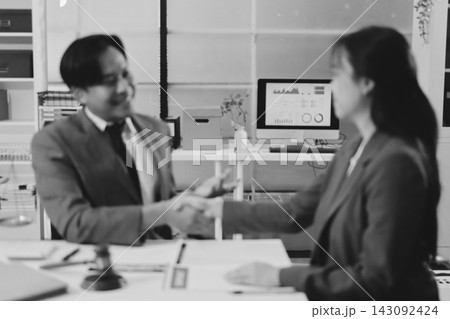 Businessmen or lawyers working together at a meeting, teamwork and partnership. Signing documents, contracts, checking details business agreement Businessmen or lawyers working together at a meeting, teamwork and partnership. Signing documents, contracts, checking details business agreement 143092424