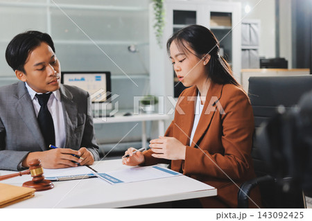 Businessmen or lawyers working together at a meeting, teamwork and partnership. Signing documents, contracts, checking details business agreement 143092425