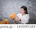 Startup SME freelance woman checking the parcel box before shipping to the customer. Successful entrepreneur business woman with online sales and parcel shipping in her home office. 143095389