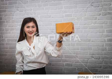 Successful entrepreneur business woman with online sales and Parcel shipping in her home office. Successful entrepreneur business woman with online sales and Parcel shipping in her home office. 143095390