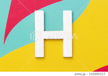 Letter H of the alphabet on colored background, top view Letter H of the alphabet on colored background, top view 143095527