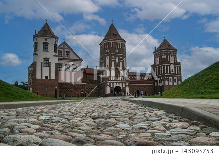 A view of the Mir Castle in Belarus from a old stone road. 143095753
