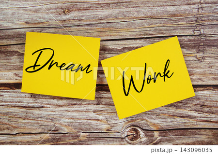 Dream vs Work text written on paper notes top view on wooden background 143096035