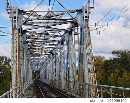 Perspective Through Weathered Railway Bridge Over River	 143096102