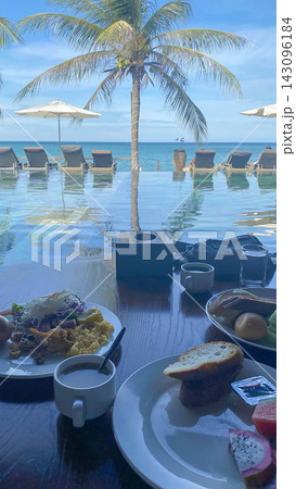 Tropical Resort Pool With Palm Tree and Breakfast by Oceanfront Loungers Tropical Resort Pool With Palm Tree and Breakfast by Oceanfront Loungers 143096184