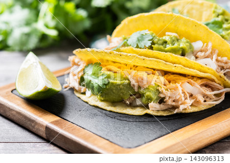 Mexican chicken tacos with guacamole and cilantro Mexican chicken tacos with guacamole and cilantro 143096313