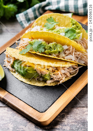 Mexican chicken tacos with guacamole and cilantro 143096316
