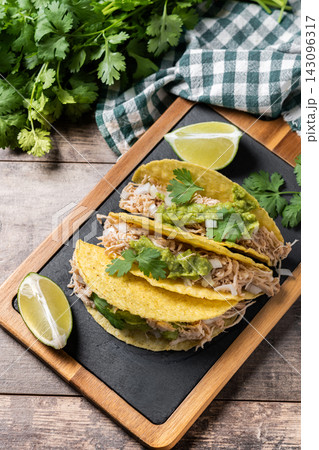 Mexican chicken tacos with guacamole and cilantro Mexican chicken tacos with guacamole and cilantro 143096317