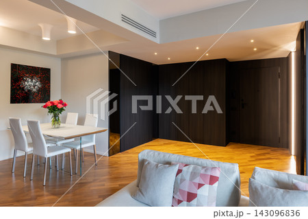 Bright dining corner and dark paneled hall in contemporary Italian apartment Bright dining corner and dark paneled hall in contemporary Italian apartment 143096836
